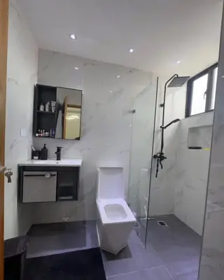 a bathroom with a toilet and a sink and a shower at Los Corales del Sur- Entire rental unit in Santo Domingo Este, Dominican Republic in Ensanche Savica de Mendoza