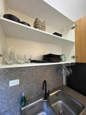 a kitchen counter with a sink and some dishes at Los Corales del Sur- Entire rental unit in Santo Domingo Este, Dominican Republic in Ensanche Savica de Mendoza