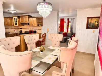 a kitchen and living room with a table and chairs at Cozy Huge and Lovely 3 bedrooms apts 2bathdrooms in La Estrella