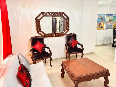a living room with two chairs and a mirror at Cozy Huge and Lovely 3 bedrooms apts 2bathdrooms in La Estrella