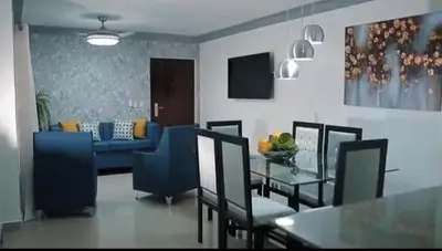 a dining room with a table and a blue couch at Mediterraneo in Canabacoa
