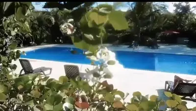 a swimming pool with two chairs and a swimming pool at Airbnba304 in Canabacoa