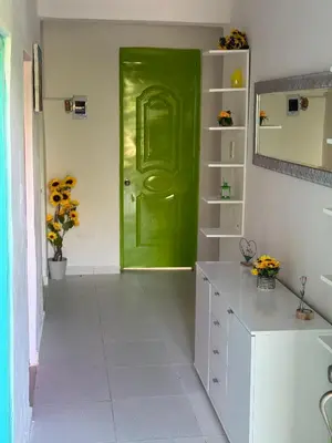 a green door in a white kitchen with a counter at Rancho Doña Rita in Higuey