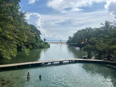 two people standing in the water near a river at 2 Bdrm, 1 Bath, Wifi, Near River and Beach, 3R in Paraíso