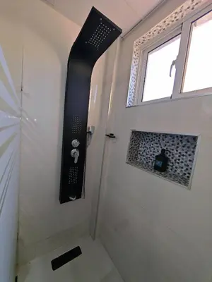 a bathroom with a shower with a window at 2 Bdrm 1 Bath Near River and Beach, 3L in Paraíso