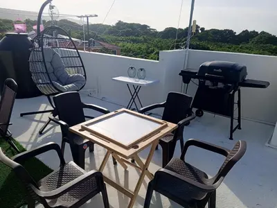 a patio with chairs and a table and a grill at Apartment-View-Beach-Mountains-Rivers-WiFi-AC-CLB in Santa Cruz de Barahona