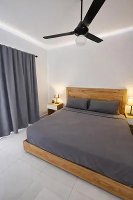 a bedroom with a bed with a ceiling fan at Ivy Villa Cabarete, fully equipped villa in Cabarete