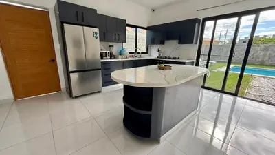 a kitchen with a large island in the middle of it at Ivy Villa Cabarete, fully equipped villa in Cabarete