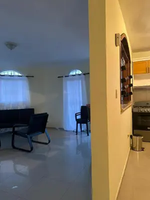 a living room with two chairs and a kitchen at Tu escape natural - No incluye bebidas, tiene costo adicional in Miches