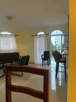a living room with a couch and chairs and windows at Tu escape natural - No incluye bebidas, tiene costo adicional in Miches