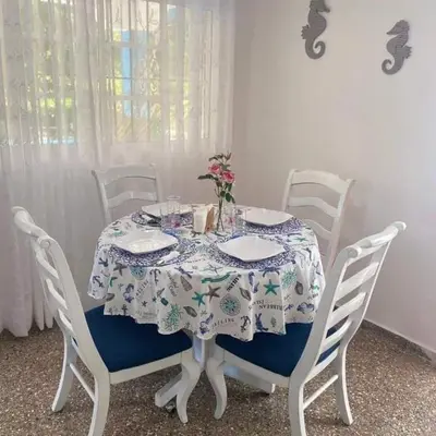 a dining room table with a blue and white table cloth at Casita Linda Playas Rios Wifi Agua HOT AC and more in Paraíso