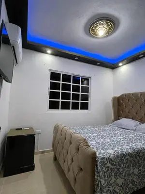 a bedroom with a bed with a blue ceiling at Departamento a 15 minutos de la playa in Imbert