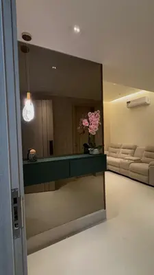 a large mirror in a room with a living room at Apartment in Evaristo Morales, National District in Santo Domingo