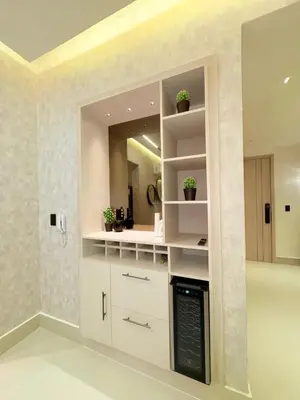 a kitchen with white cabinets and a mirror at Apartment in Evaristo Morales, National District in Santo Domingo