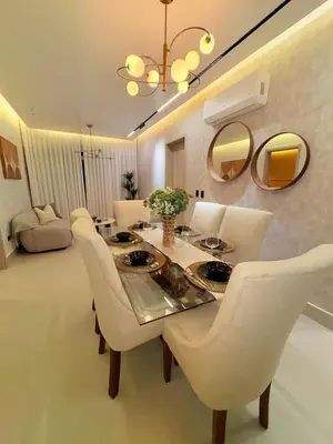 a dining room with white chairs and a table and mirrors at Apartment in Evaristo Morales, National District in Santo Domingo