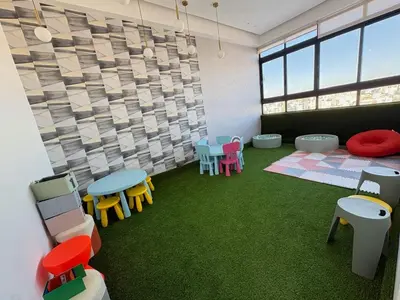 a room with colorful tables and chairs in it at Apartment in Evaristo Morales, National District in Santo Domingo