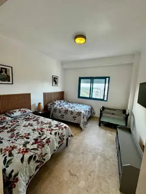 a bedroom with two beds and a window at Juan Dolio 2BR Apt Beach front in Juan Dolio