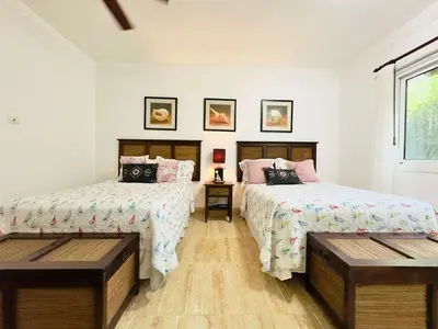 a bedroom with two beds and a window at Oceanfront Unit Jacuzzi Balconies of Atlantic in El Limón