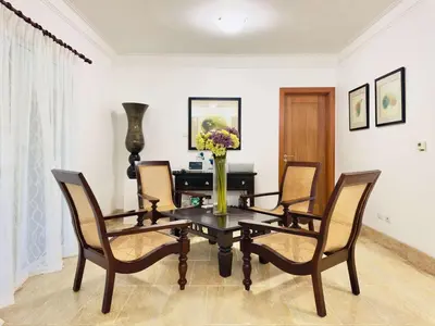 a dining room table with chairs and a vase of flowers at Oceanfront Unit Jacuzzi Balconies of Atlantic in El Limón
