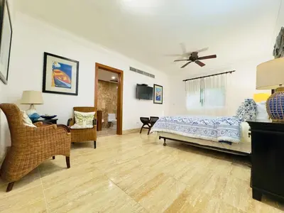 a bedroom with a bed and a ceiling fan at Oceanfront Unit Jacuzzi Balconies of Atlantic in El Limón