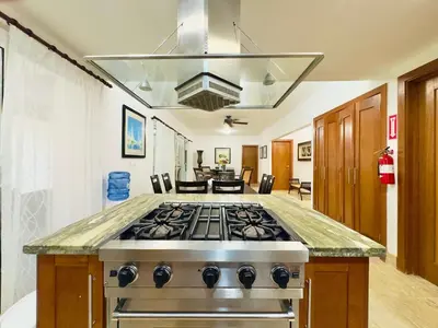 a kitchen with a stove top oven in a room at Oceanfront Unit Jacuzzi Balconies of Atlantic in El Limón