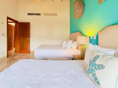 a hotel room with two beds and a blue wall at Oceanfront PH Jacuzzi Balconies of the Atlanti in El Limón