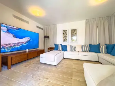 a living room with a large flat screen tv at Villa 1 min walk from the beach in Las Terranas in El Limón