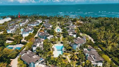 an aerial view of a resort with a pool at Villa 1 min walk from the beach in Las Terranas in El Limón