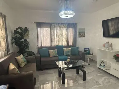 a living room with a couch and a table at Alma Stay Central and cozy in Santa Bárbara de Samaná