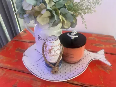 a table with a candle and a vase with flowers at Alma Stay Central and cozy in Santa Bárbara de Samaná