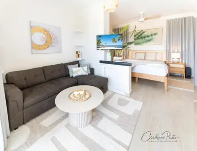 a living room with a couch and a bed at Modern Caribbean Stay Coral Azul 301 in La Laguna
