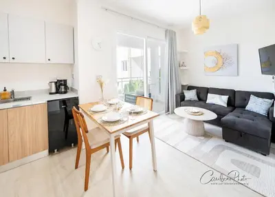 a kitchen and living room with a table and a couch at Modern Caribbean Stay Coral Azul 301 in La Laguna