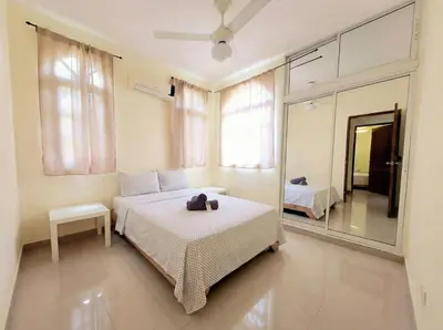 a bedroom with a bed and a mirror at 2-Bedroom Beach Apartment 50m from the Sea and Pool in San Felipe de Puerto Plata