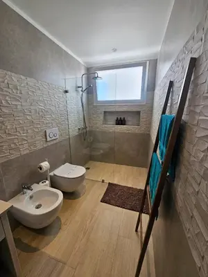 a bathroom with a sink and a toilet and a shower at Aqua Esmeralda Beachfront Apartment Trinidad 103 in La Laguna