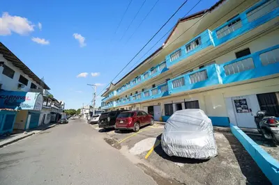 a building with a tent parked in a parking lot at Cheap Hotel Room in Sosua Center in Sosúa
