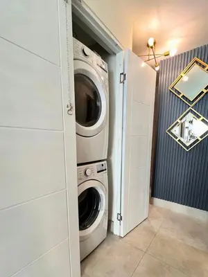 a laundry room with a washer and dryer at Majestic 2Bd Ocean view Apartment Boca Del Mar III in Boca Chica