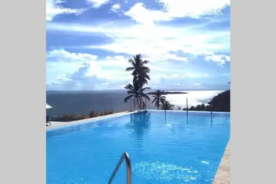 a swimming pool with a view of the ocean at Spectacular Ocean View 1-Bedroom Condo, Vista Mare, Samana, DR in Villa Ramfis