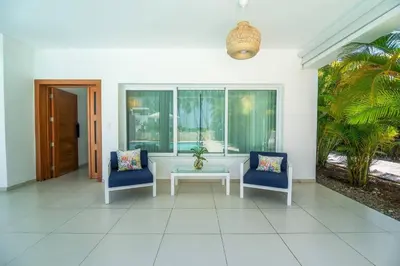 a living room with two chairs and a table at Lux villa playa bonita in Las Terrenas