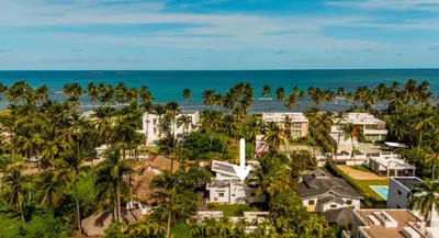 an aerial view of a resort with palm trees and the ocean at Lux villa playa bonita in Las Terrenas