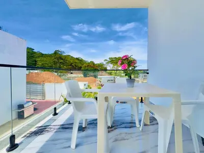 a white table and chairs on a balcony with a view at Villa Las Terrenas Near Playa Bonita Pool in Las Terrenas