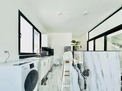 a white kitchen with a sink and a dishwasher at Villa Las Terrenas Near Playa Bonita Pool in Las Terrenas