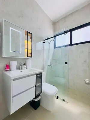 a bathroom with a toilet and a glass shower at Villa Las Terrenas walk to Punta Popy Pool, AC in Las Terrenas