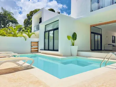 a swimming pool in front of a house at Villa Las Terrenas walk to Punta Popy Pool, AC in Las Terrenas