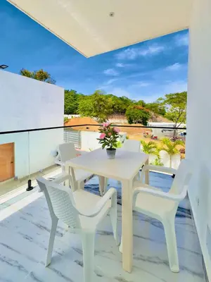 a white table and chairs on a balcony at Villa Las Terrenas walk to Punta Popy Pool, AC in Las Terrenas