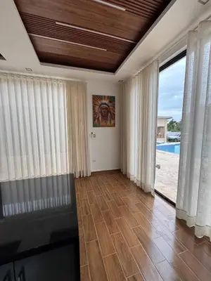 a living room with a view of a pool at Las Indgenas 6BR Pool Jacuzzi Gazebo in Imbert