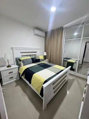 a bedroom with a large bed and a large mirror at Modern apartment in Santo Domingo in Juan López