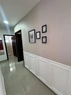 a hallway with three pictures on a wall at Modern apartment in Santo Domingo in Juan López