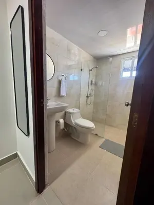 a bathroom with a toilet and a sink and a shower at Modern apartment in Santo Domingo in Juan López