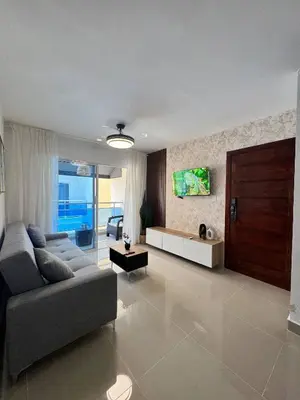 a living room with a couch and a tv at Modern apartment in Santo Domingo in Juan López