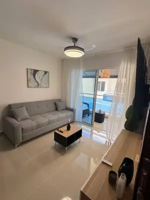a living room with a couch and a table at Modern apartment in Santo Domingo in Juan López